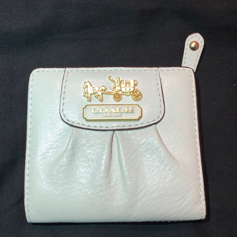 Coach Women’s white leather wallet.